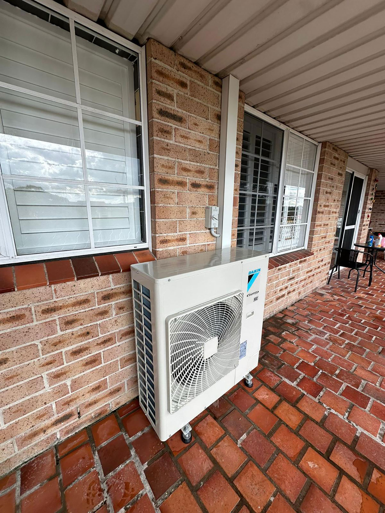 Licensed Toptech Air technician installing a split system air conditioner on an interior wall in Sydney
