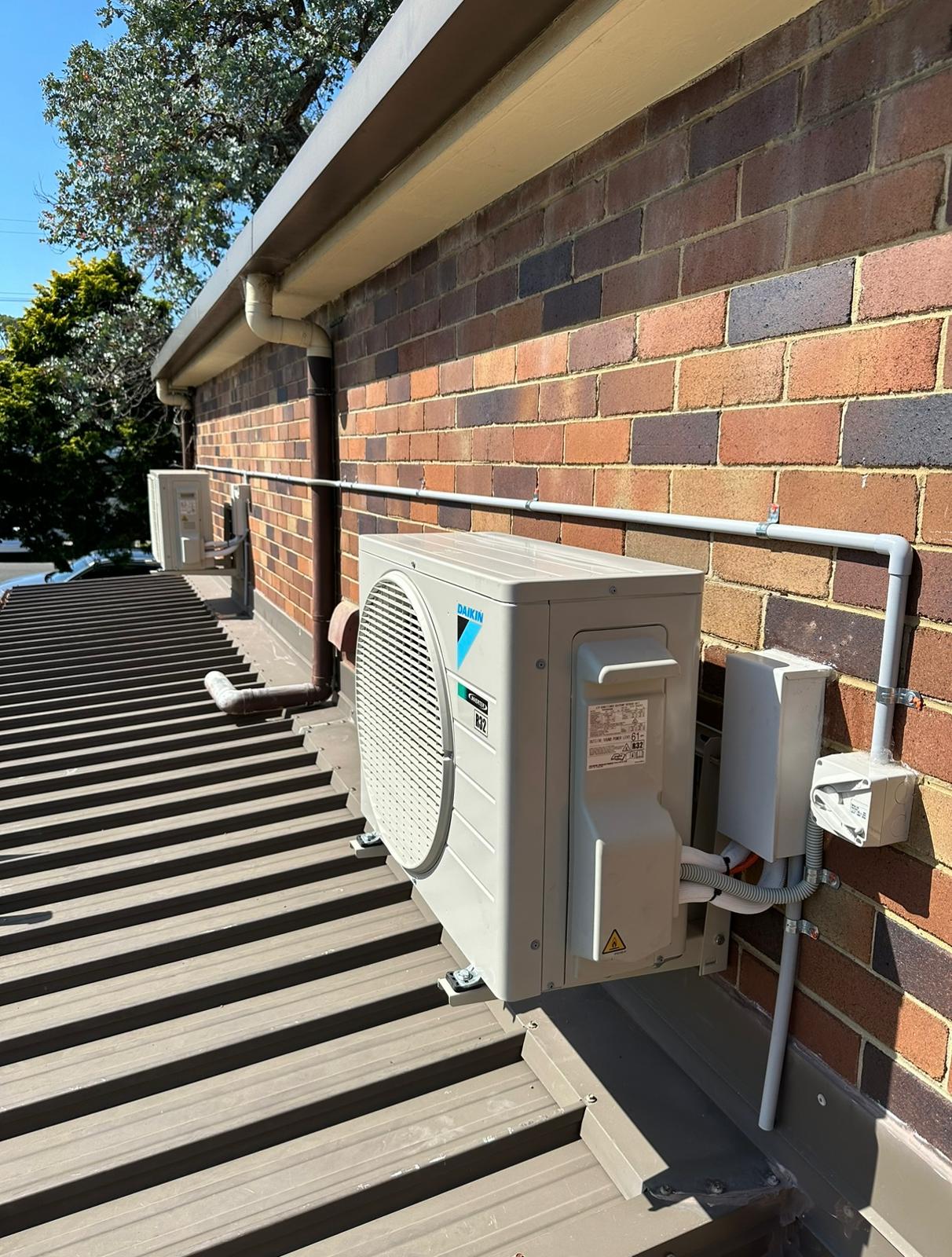 Toptech Air technician neatly routing refrigerant pipework during an air conditioner installation in Sydney